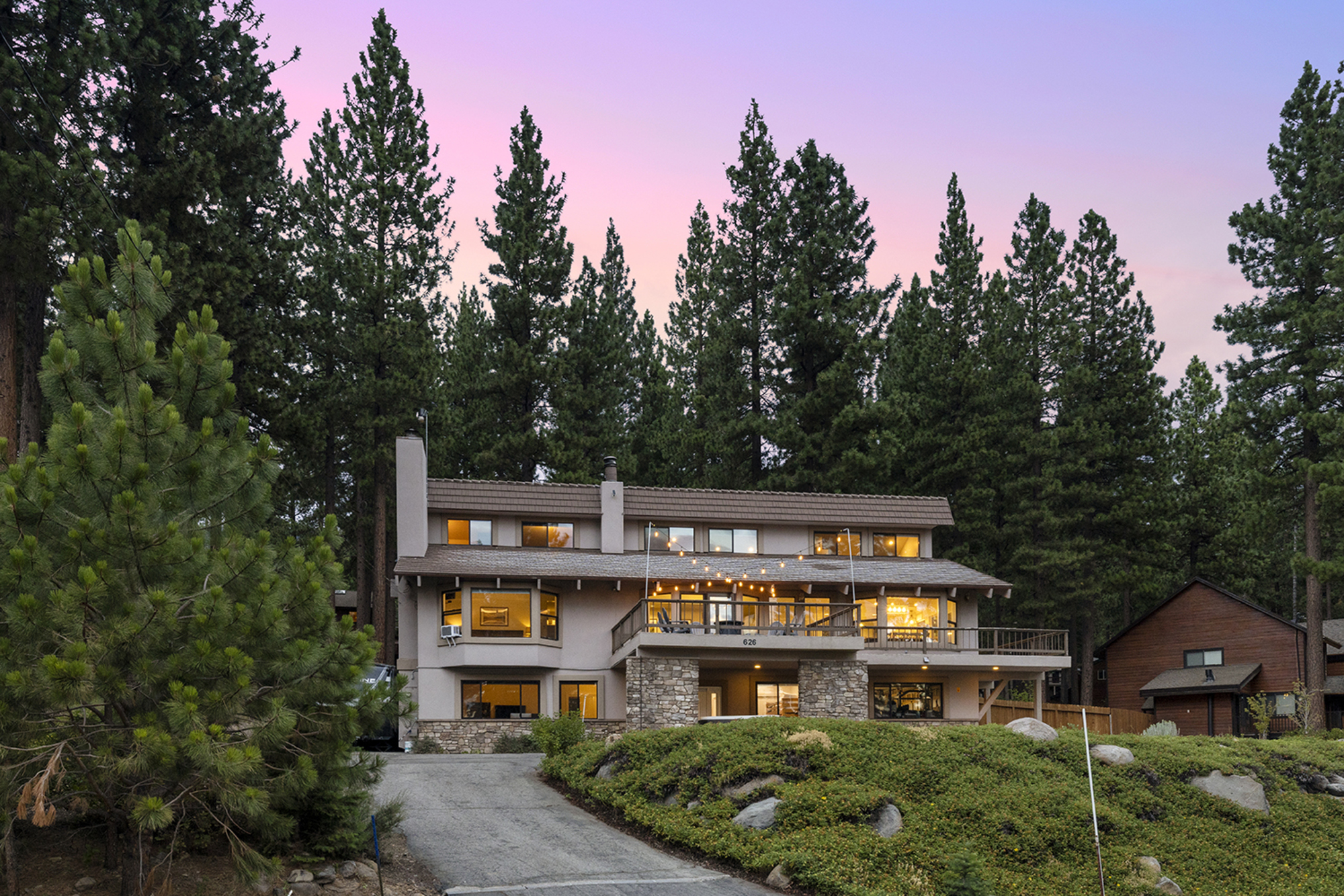 Kinpine House exterior at dusk showing full home and forest setting