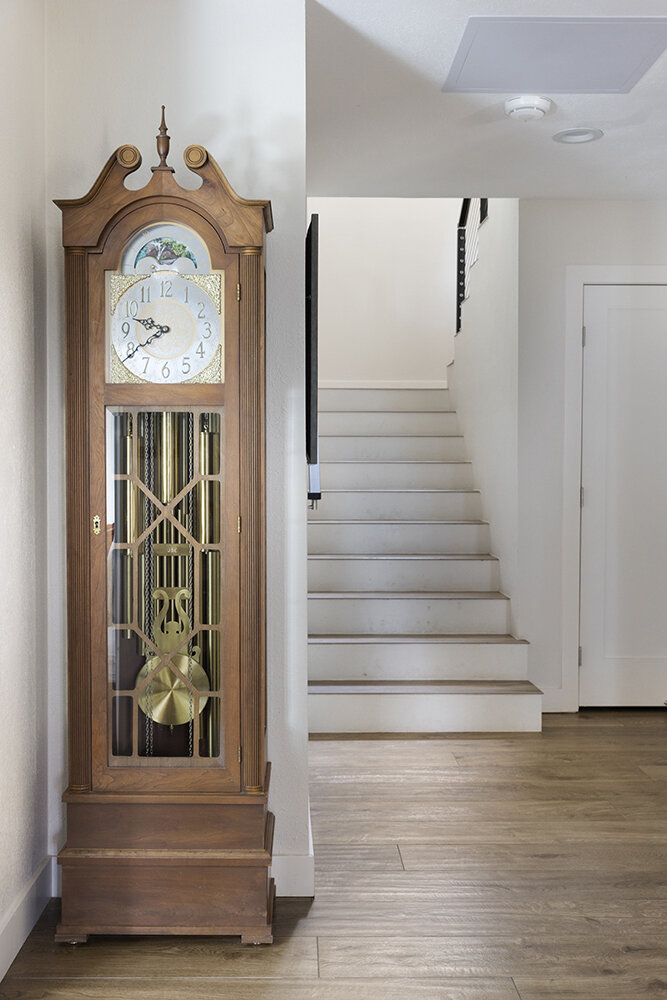 Grandfather clock in the entry hall at the foot of the stairs