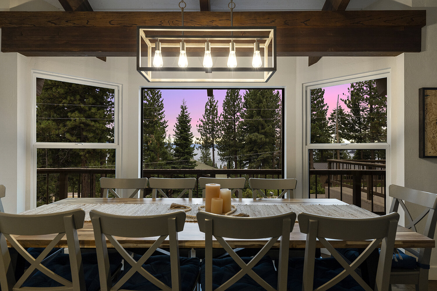 The lake and dusk sky framed in the dining room windows at Kinpine House